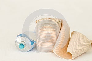 Topical medication with roll bandage for first aid accident