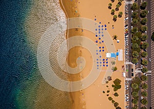 Topl view of Las Teresitas beach, road, cars in the parking lot, golden sand beach and the Atlantic Ocean. Tenerife, Canary