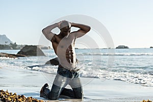 Topless african black man on beach