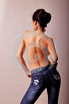 Topless asian woman in blue jeans