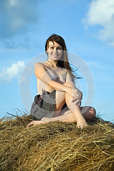 Topless girl hay bale