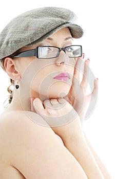 Topless lady in black plastic eyeglasses and cap