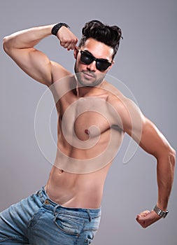 Topless man flexing his arms