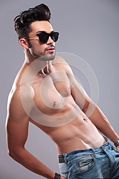 Topless man with hand in back pocket