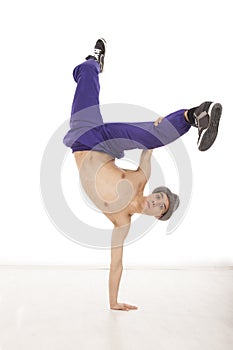 Topless man with hat dancing and sitting on one hand