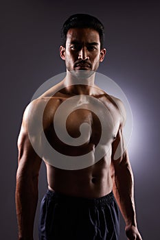 Topless, muscle and portrait of Asian man in dark background for fitness inspiration, beauty aesthetic or healthy body
