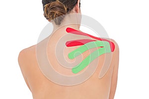 Topless woman with red and green strips on shoulder