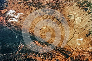 Topo of the badlands - aerial view of wild rough country in the western USA with ravines and cliffs and clouds