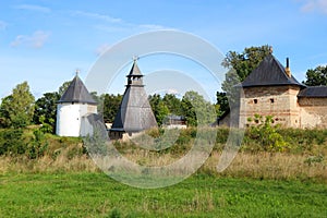 The tops of the fortress wall towers of Pskov-Pechory Dormition Monastery in Pechory, Pskov region, Russia under blue sky