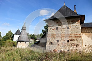 The tops of the fortress wall towers of Pskov-Pechory Dormition Monastery in Pechory, Pskov region, Russia under blue sky