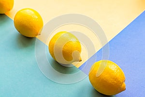 Topv view of three lemons on colorful pastel background