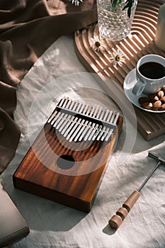 Topview girl playing Kalimba, acoustic music instrument from africa. Kalimba conceptRelaxation methods and techniques through anti