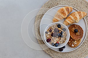 Topview image of yummy breakfast. Granola with berries, croissan