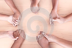 Topview of parent and children holding hands and praying