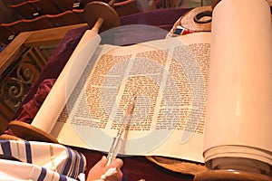 Torah hand of boy reading the Jewish Torah at Bar Mitzvah reading Jewish books