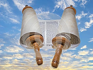 The Torah scroll is directed to infinity against the backdrop of a sunset