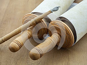 Torah scrolls on a wooden table.