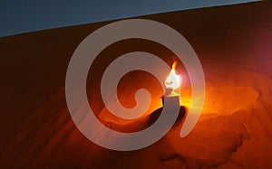 Torch in desert sand