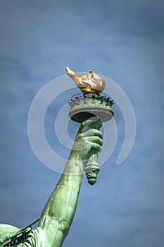 The torch of Lady Liberty on a cloudy day