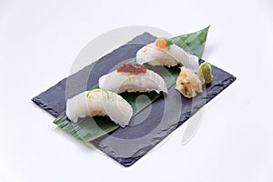 Torched Engawa Sushi Topping with Lime, Chilli Jam and Minced Daikon Served with Wasabi and Prickled Ginger.
