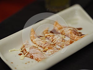 Torched Salmon Aburi Saikyo Sushi with sweet sauce on white plate, Japanese food