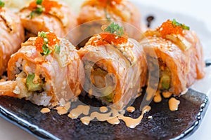 Torched Salmon Roll with Prawn Tempura Inside.Topping with Cheese, Ebiko Prawn Eggs, Scallion and White Sesame