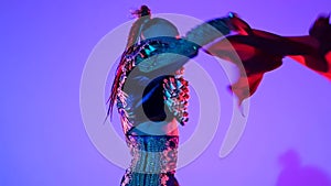 Torero in blue and gold suit or typical Spanish bullfighter isolated over on a blue background. Close up, slow motion.