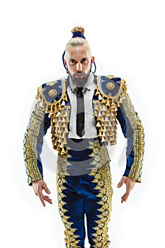 Torero in blue and gold suit or typical spanish bullfighter isolated over white