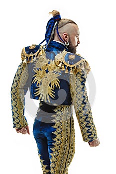 Torero in blue and gold suit or typical spanish bullfighter isolated over white