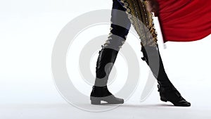 Torero in blue and gold suit or typical Spanish bullfighter isolated over white studio background. Close up of legs