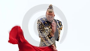 Torero in blue and gold suit or typical spanish bullfighter isolated over white studio background. Close up, slow motion