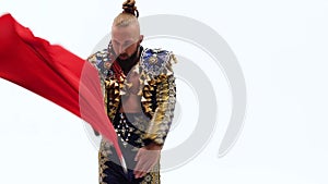 Torero in blue and gold suit or typical spanish bullfighter isolated over white studio background. Close up, slow motion