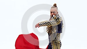 Torero in blue and gold suit or typical spanish bullfighter isolated over white studio background. Close up, slow motion