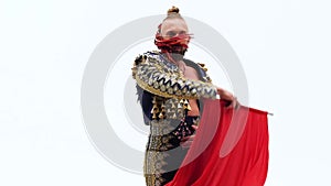 Torero in blue and gold suit or typical Spanish bullfighter isolated over white studio background. Close up, slow motion