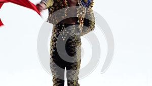 Torero in blue and gold suit or typical Spanish bullfighter isolated over white studio background. Close up, slow motion