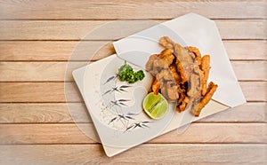 Tori kawa no karaage - japanese style deep fried chicken skin with salt and lime on wooden background , stock photo