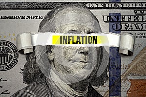 Torn bills revealing Inflation words. Idea for FED consider interest rate hike, world economics and inflation control, US dollar i photo