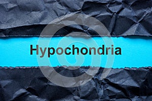 Torn black paper and word hypochondria. photo