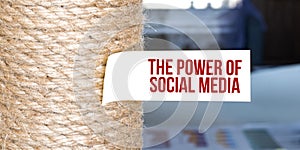 Torn brown paper on white surface with text THE POWER OF SOCIAL MEDIA word