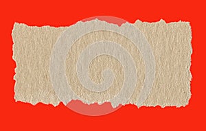 Torn brown recycle paper on bright red background