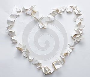 Torn crumpled paper heart shape