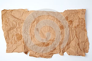 Torn crumpled piece of brown paper with grease stains