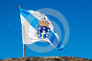 Torn Galicia flag in the wind photo