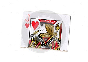 A torn half of a jack of hearts playing card.