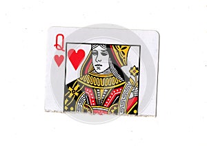 A torn half of a queen of hearts playing card.