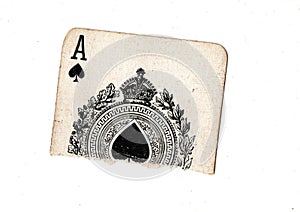 A torn half of a vintage ace of spades playing card.