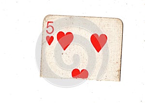 A torn half of a vintage five of hearts playing card.