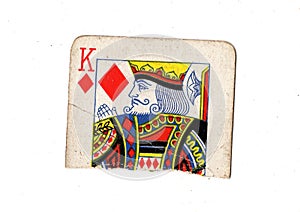 A torn half of a vintage king of diamonds playing card.