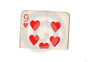 A torn half of a vintage nine of hearts playing card.