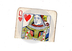 A torn half of a vintage queen of hearts playing card.